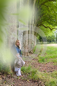 Beautiful blonde leaning against a tree
