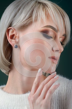 Beautiful blonde with luxurious silver jewelry. Woman wears silver jewelry