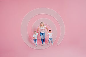 Beautiful blonde mom with two happy sons. Young woman and two baby boys,