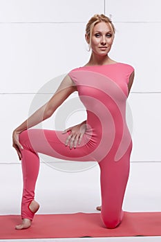 Beautiful blonde perfect athletic slim figure engaged in yoga, pilates, exercise or fitness, lead healthy lifestyle, and