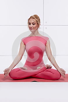 Beautiful blonde perfect athletic slim figure engaged in yoga, pilates, exercise or fitness, lead healthy lifestyle, and