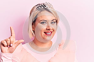 Beautiful blonde plus size woman wearing pincess tiara with diamonds over pink background smiling with an idea or question