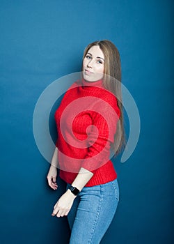 Beautiful blonde in  red sweater  on  blue background