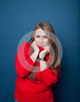 Beautiful blonde in  red sweater  on  blue background