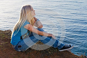 Beautiful blonde on sea background