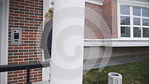 Beautiful blonde shows the keys to their new apartments in a stylish brick house. She is happy