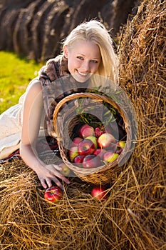 Beautiful blonde smiling woman with many apple