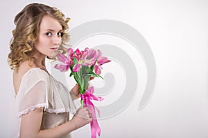 Beautiful blonde spring girl with flowers