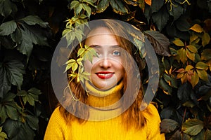 Beautiful girl walking outdoors in autumn park. Smiling Young woman enjoying autumn weather.