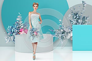 A beautiful blonde woman, adorned in a retro-style dress and hairdo, striking a pose in a studio adorned with flowers. Perfect for