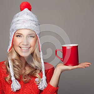 Beautiful blonde woman with an aromatic hot coffee in hand.