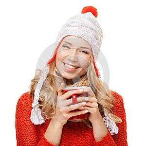 Beautiful blonde woman with an aromatic hot coffee in hands.