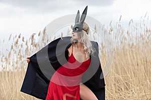 Beautiful blonde woman in black animal mask