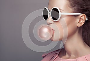 Beautiful blonde woman blowing bubble gum. Fashion portrait. photo