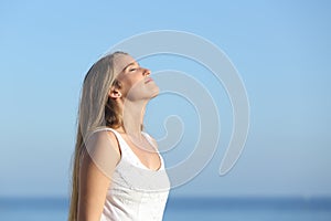 Beautiful blonde woman breathing happy