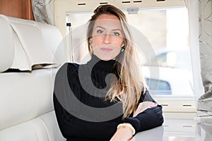Beautiful blonde woman in campervan motor van home vanlife vacation in camper RV car
