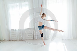 beautiful blonde woman dancing to music in training