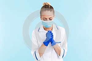 Beautiful blonde woman doctor wearing uniform standing