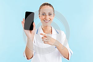 Beautiful blonde woman doctor wearing uniform standing