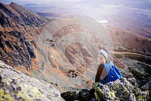 Beautiful blonde woman enjoys the moment while hiking in the Slovak Tatra Mountains on Mount Kryvan.