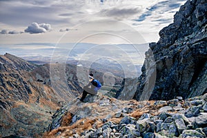 Beautiful blonde woman enjoys the moment while hiking in the Slovak Tatra Mountains on Mount Kryvan.