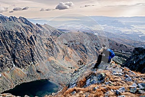 Beautiful blonde woman enjoys the moment while hiking in the Slovak Tatra Mountains on Mount Kryvan.