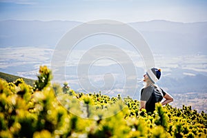 Beautiful blonde woman enjoys the moment on a mountain hike in the Slovak Tatra Mountains