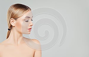 Beautiful blonde woman face, female profile on white background. Facial treatment, skin care and cosmetology concept