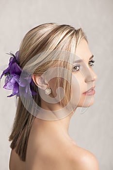 Beautiful blonde woman with flower hairclip