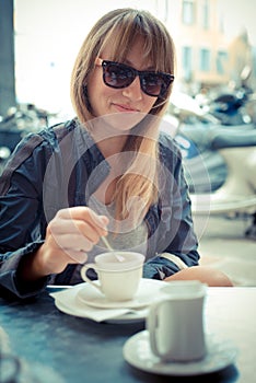 Beautiful blonde woman having breakfast at the bar