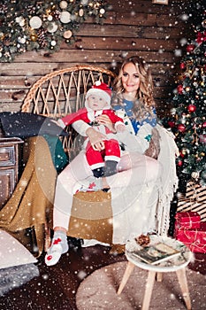 Beautiful blonde woman and her child enjoying Christmas at home