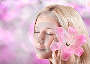 Beautiful blonde woman with lily flower