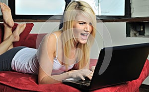 Beautiful blonde woman lounging - laptop