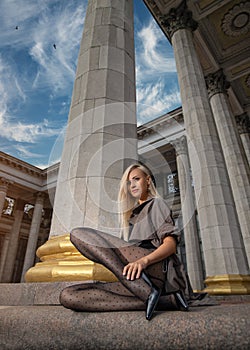 Beautiful blonde woman with perfect legs in pantyhose posing outdoor at the autumn street