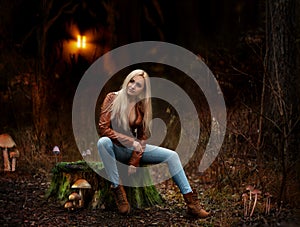 Beautiful blonde woman posing outdoor in the autumn forest