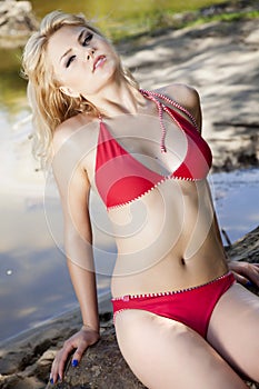 Beautiful blonde woman in red bikini