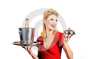 Beautiful blonde woman in red dress with retro hairstyle. Happy girl with champagne bottle and tray. Pin up style. Happy