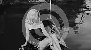 Beautiful blonde woman riding on Gondola. Travels concept