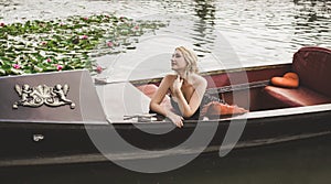 Beautiful blonde woman riding on Gondola. Travels concept