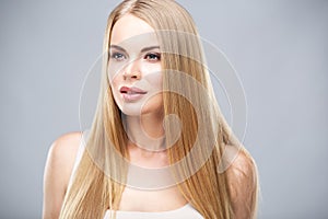 Beautiful blonde woman with shiny long straight hair and natural fresh make up. Fashion beauty portrait 