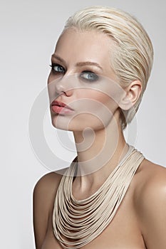 Beautiful blonde woman with smoky eye make-up and stylish