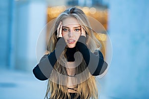 Beautiful blonde woman in summer city. Trendy girl posing on the street background. Fashion model wear trendy dress