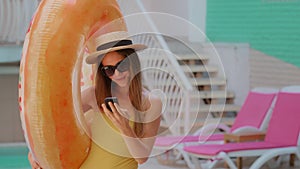 Beautiful blonde woman tourist stylish female blogger girl lady in swimsuit with inflatable lifebuoy make selfie on