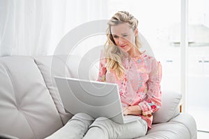 Beautiful blonde woman using laptop