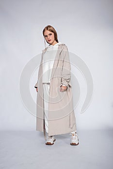 Beautiful blonde woman wear of white set of tracksuit isolated