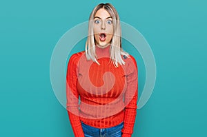 Beautiful blonde woman wearing casual clothes afraid and shocked with surprise and amazed expression, fear and excited face