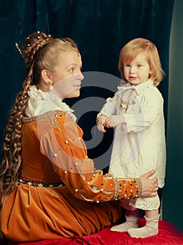 Beautiful blonde woman wearing renaissance dress playing with Li