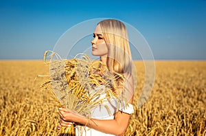 Beautiful blonde woman in a wheat field