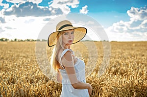 Beautiful blonde woman in a wheat field