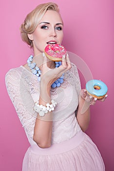 Beautiful blonde women taste colorful dessert. Fashion shot. Soft colors